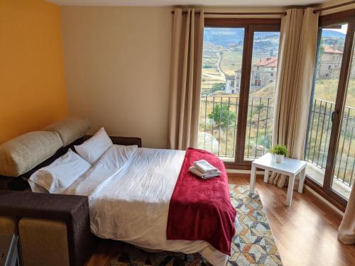 a bedroom with a bed and a large window at Apartamento Las Vistillas in Valdelinares