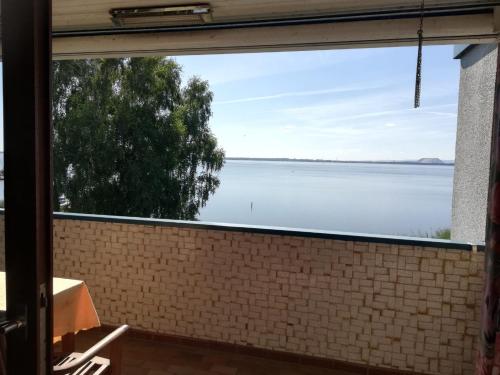 a view of the water from the window of a house at Ferienwohnung direkt am Steinhuder Meer in Neustadt am Rübenberge