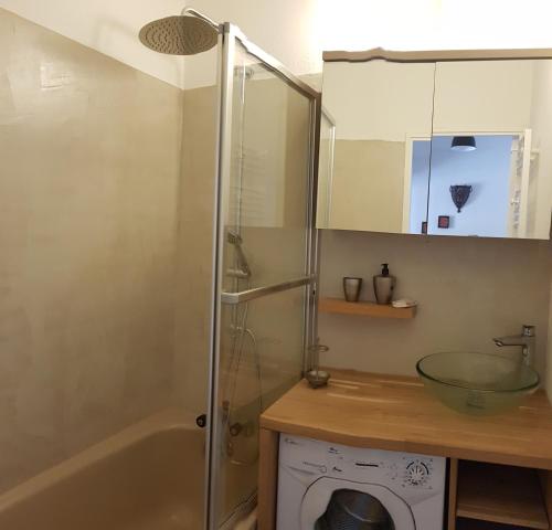 a bathroom with a shower and a sink and a tub at Établissement Central Parc in Briançon