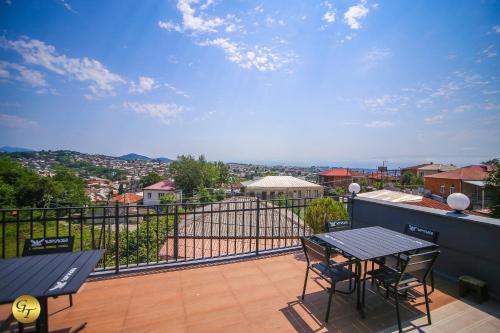 a balcony with a table and chairs and a view at Hotel Green Town in Kutaisi