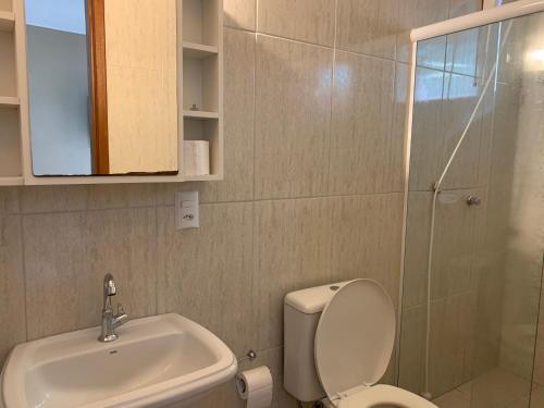 a bathroom with a toilet and a sink and a shower at Espaço Praia - Studio 109 in Angra dos Reis
