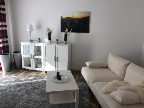 a living room with a couch and a table at Ferienhof Kröger in Bielefeld