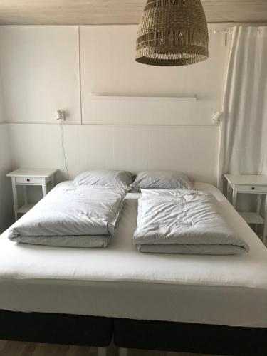 En eller flere senge i et værelse på Seaside VØ