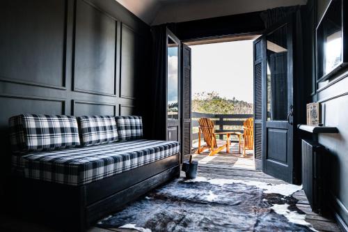 a couch sitting in theoyer of a house at Ort Hotel in Campos do Jordão