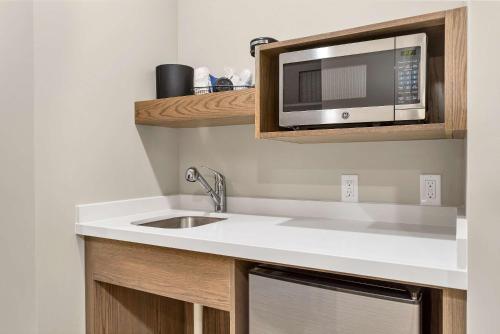 a kitchen with a sink and a microwave at Best Western Plus Zion Canyon Inn & Suites in Springdale