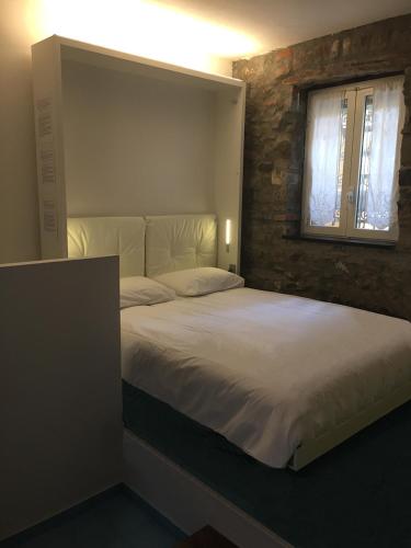 a bedroom with a large white bed with a window at Monterosso al Mare 20 in Monterosso al Mare
