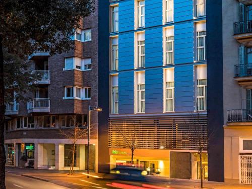 a blue building on the side of a street at ibis Styles Barcelona Centre in Barcelona