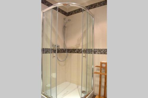 a shower with a glass enclosure in a bathroom at Modern apartments - Airport 8mins in Prague