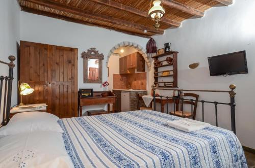 a bedroom with a bed and a kitchen at Naxos Filoxenia Hotel in Galini