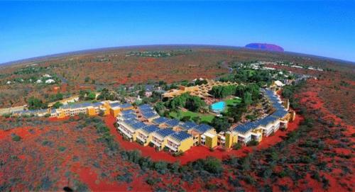 a scenic view of a city with mountains at The Lost Camel Hotel in Ayers Rock