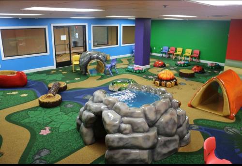 a childrens play room with a play area with play tents at Wyndham Lancaster Resort and Convention Center in Lancaster