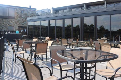 an outdoor patio with tables and chairs and windows at Wyndham Lancaster Resort and Convention Center in Lancaster
