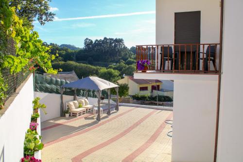 a balcony of a house with a gazebo at Casa de Agrelos in Ponte da Barca