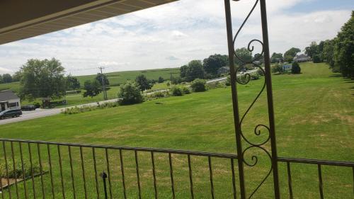 a view of a green field from a balcony at Travelodge by Wyndham Hershey in Hershey