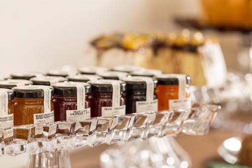 a group of jars of honey on a shelf at Dimora Clementina in Putignano