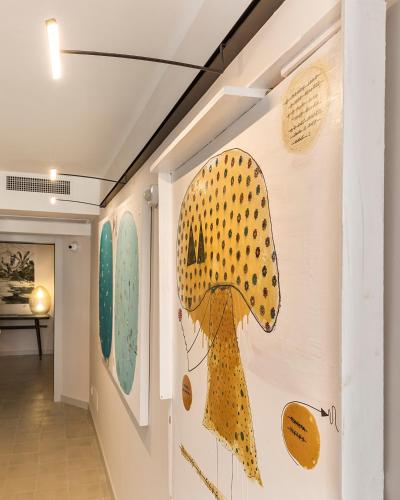 a hallway with paintings on the wall at Dimora Clementina in Putignano