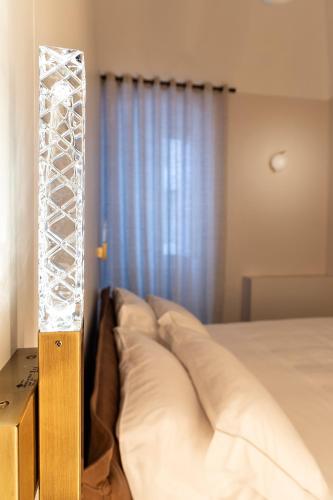 a glass light in a bedroom with a bed at Dimora Clementina in Putignano
