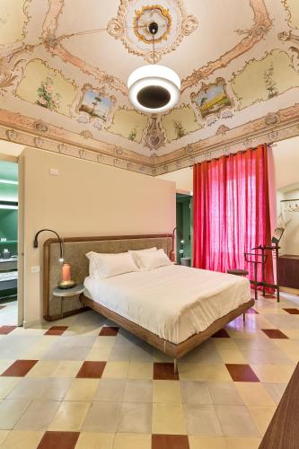a bedroom with a large bed and a ceiling at Dimora Clementina in Putignano