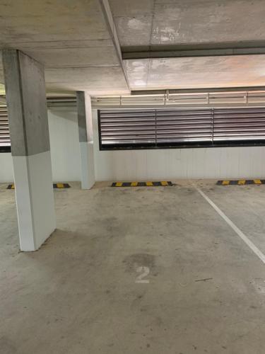 an empty parking lot in an empty parking garage at Rockpool 2 Sawtell Beach - Just steps to Restaurants and 2 min Stroll to Beach! in Sawtell