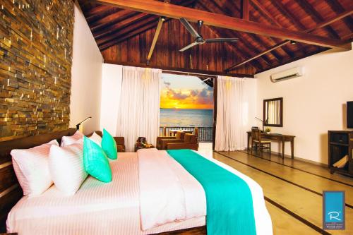 a bedroom with a bed with a view of the ocean at R Degrees in Ambalangoda