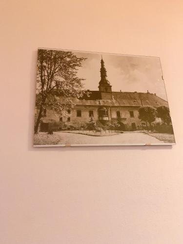 a picture of a building on a wall at Zámek Ruda nad Moravou in Ruda na Moravě