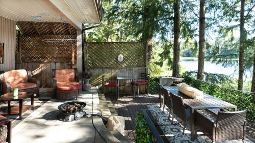a patio with a table and chairs and a fire pit at Willow Suite - Lakeside Retreat in Victoria