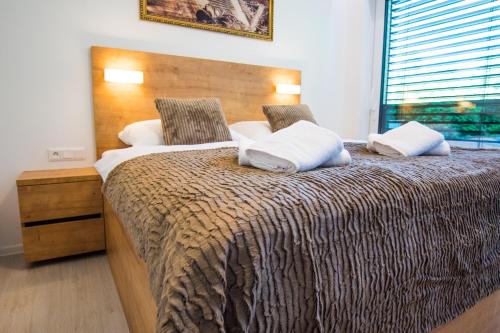 a bedroom with a large bed with a wooden headboard at Penthouse apartments in Trstená
