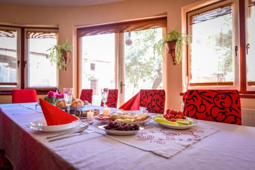 a table with plates of food and fruit on it at Villa Holiday Home Kuća za odmor Slavonka in Kaptol