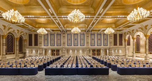 a large room filled with tables and chandeliers at InterContinental Lhasa Paradise by IHG in Lhasa