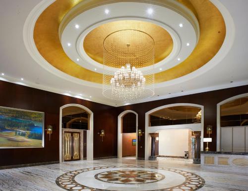 a lobby with a ceiling with a chandelier at InterContinental Lhasa Paradise by IHG in Lhasa