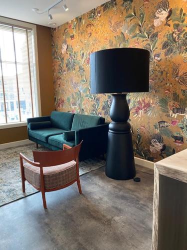 a living room with a lamp and a couch at Slot Oostende in Goes