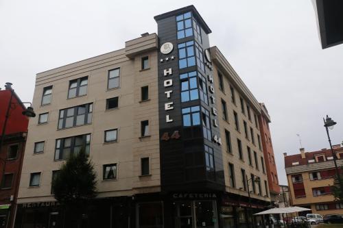 a building with a clock on the side of it at Hotel 44 in Gijón