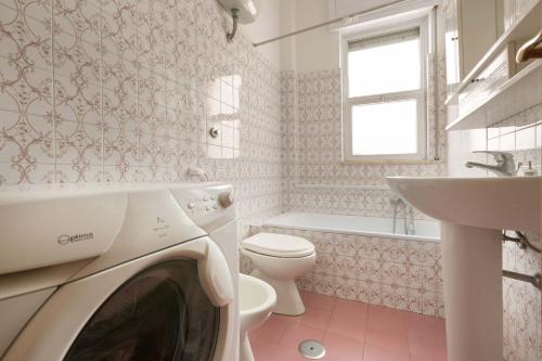 una lavatrice in bagno con lavandino e servizi igienici di Appartamento Lido San Giovanni by BarbarHouse a Gallipoli