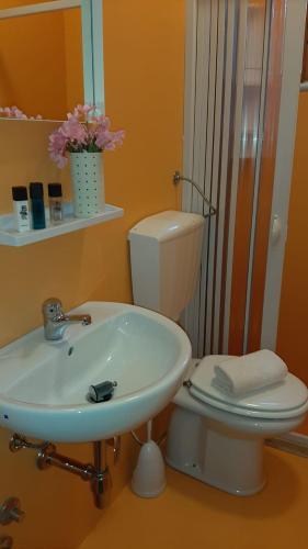 a bathroom with a white sink and a toilet at Appartamenti La Villa Peschici in Peschici