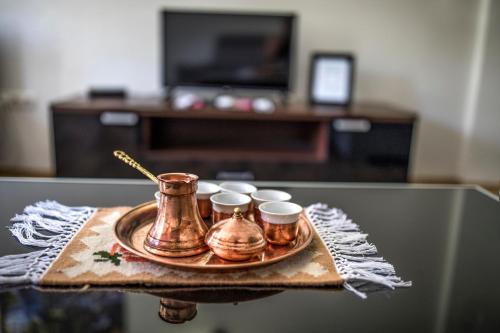 a tray with three tea cups on a table at Guesthouse Check In in Stolac