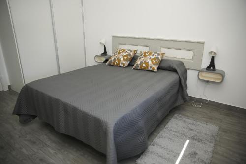a bedroom with a bed with two pillows on it at Casa da Praça in Ponte de Sor