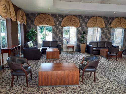 a waiting room with couches and a table and chairs at Holiday Inn Barnsley by IHG in Barnsley