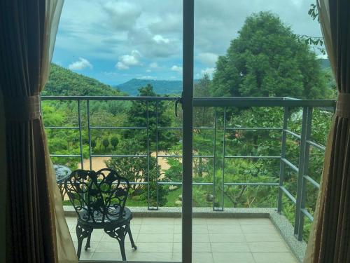 a view from a window of a balcony with a bench at 溪頭吉野民宿Ji-Ye in Lugu
