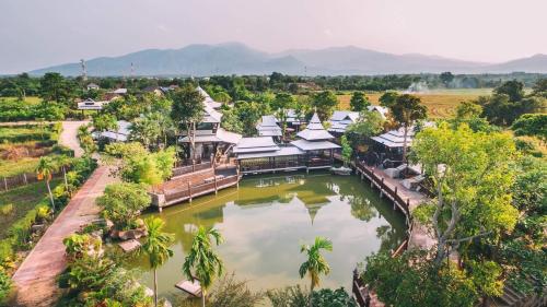 an aerial view of a resort on a river at Bantunglom Resort in Mae Rim