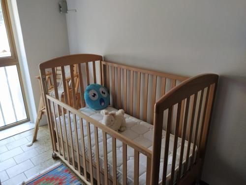 a crib with a stuffed animal sitting in it at Casa via degli Ulivi 13 in Lozzo Atestino