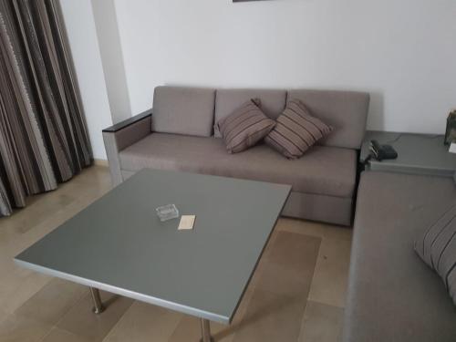 a living room with a couch and a table at Andalucia appart hoteL in Bizerte