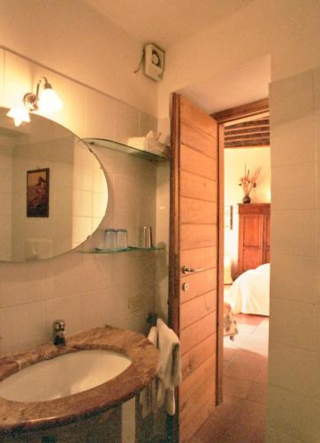 a bathroom with a sink and a mirror at La Torretta Historical Home in Casperia