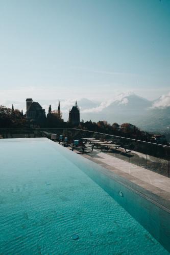 a swimming pool with a view of a mountain at Hotel Finkennest - Panoramic Garden Resort in Schenna