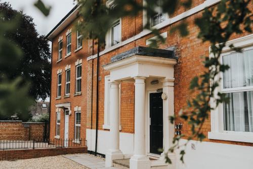 a brick building with a white front door at The Stay Company, Dalby House in Derby