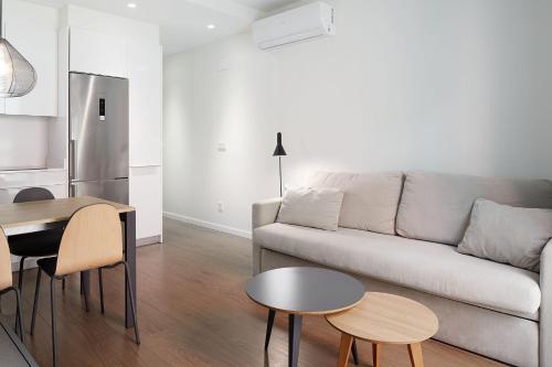 a living room with a couch and a table at Hotel SANSEbay in Donostia-San Sebastián
