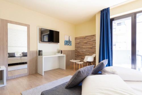 a hotel room with a bed and a tv at Arco Smart Hotel in Arco