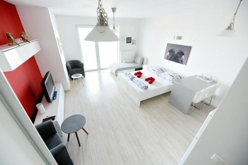 a white living room with a couch and a table at Apartmán Centroom in Piešťany