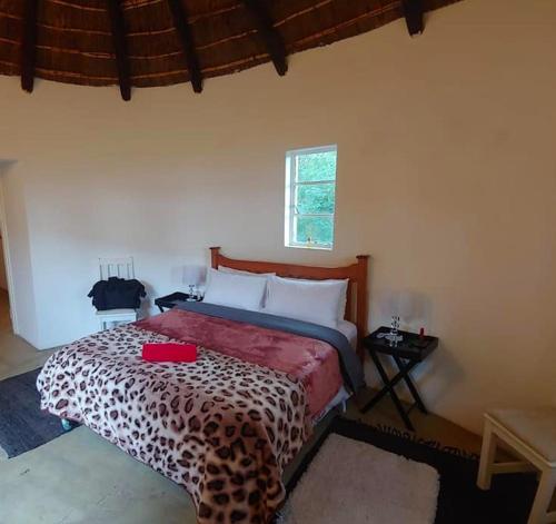 a bedroom with a bed with a leopard print bedspread at Klipfontein Rustic Farm & Camping in Tulbagh