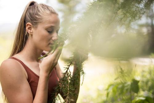 a young woman standing next to a tree at DAS GERSTL Alpine Retreat in Malles Venosta