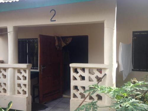 a entry to a house with a door and a fence at Leybato Beach Hotel in Fajara